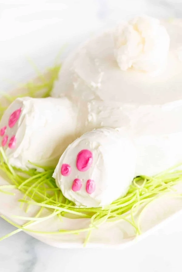 bunny butt cake on platter with green grass cotton candy tail