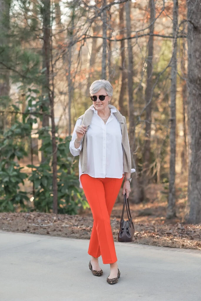 spring style tips for women over 50 color pop orange pants outfit women over 50 orange pants neutral top