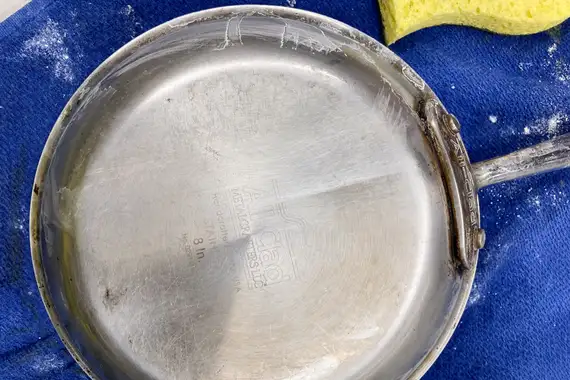 All-Clad stainless steel underside. There is a clear line in the middle of the pan where one side was scrubbed with BKF and the other with baking soda.