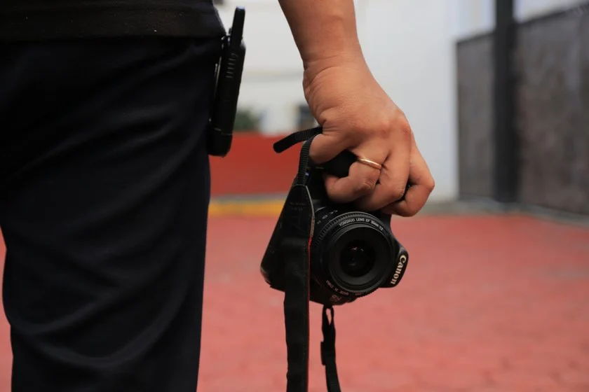 The photographer holds a camera in his hands | Skylum Blog