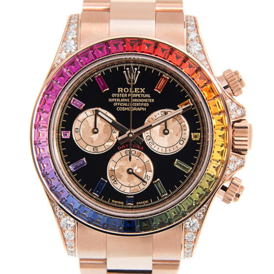 A luxury Rolex Daytona watch with a black dial, rose gold accents, three subdials, diamond hour markers, and a rainbow-colored gemstone bezel on a matching rose gold bracelet—perfect for elevating your Wrist Frequency. Lifestyle