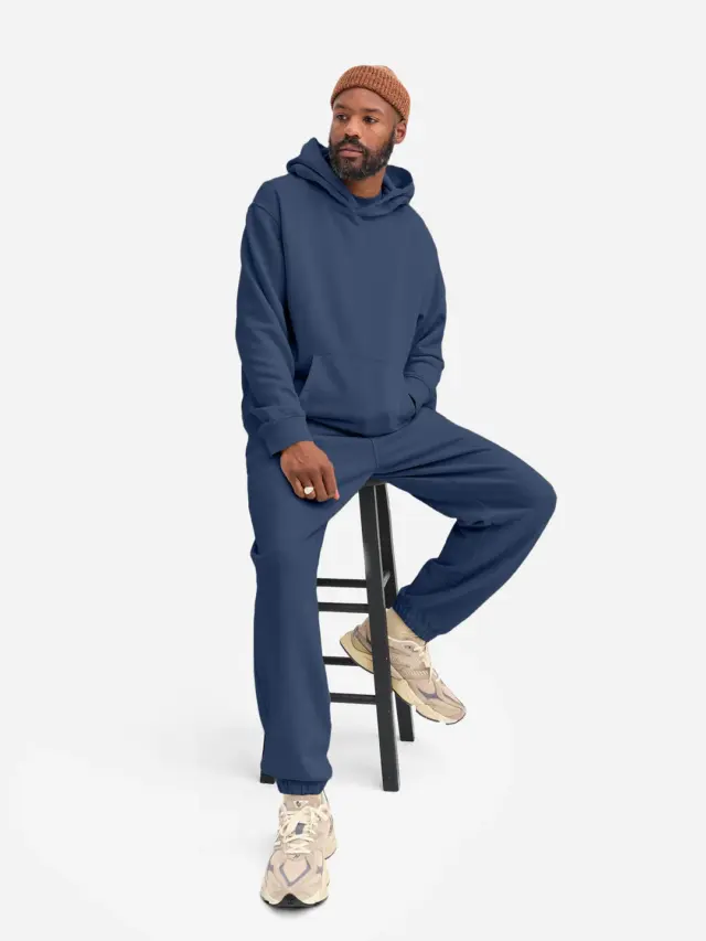 A man in a blue sweatshirt and sweatpants in a set from a friend with a label
