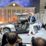 the-back-to-the-future-delorean-and-an-actor-playing-doc-brown-at-the-tamron-booth-at-cpplus-2026