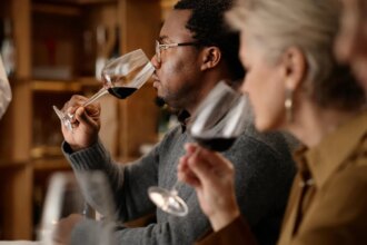 person smelling wine at restaurant table