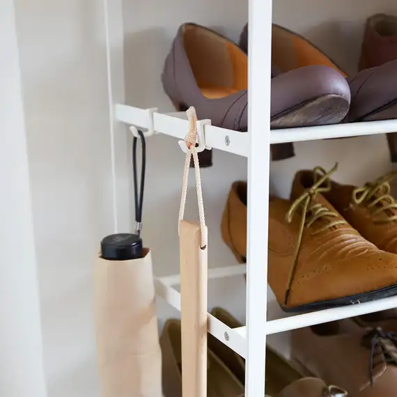 Close-up of shoes stacked on a 6-tier shoe rack in Yamazaki's home.