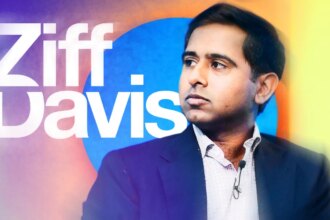 Vivek Shah, CEO of Ziff Davis, stands in front of the company logo