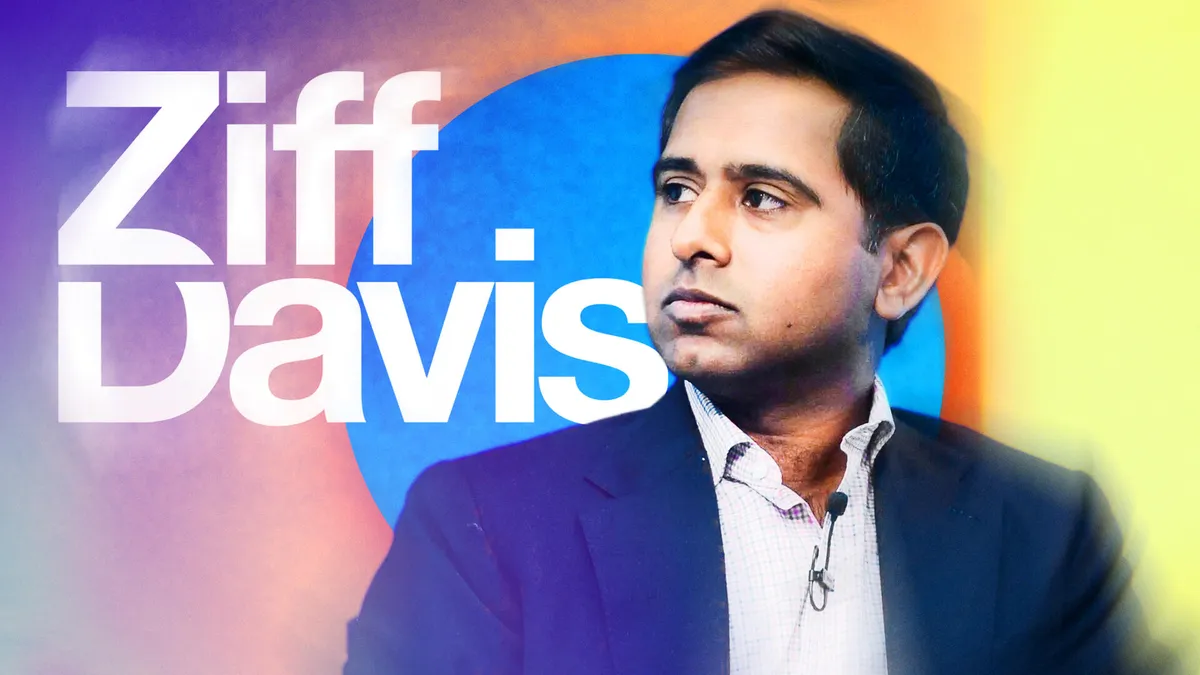 Vivek Shah, CEO of Ziff Davis, stands in front of the company logo