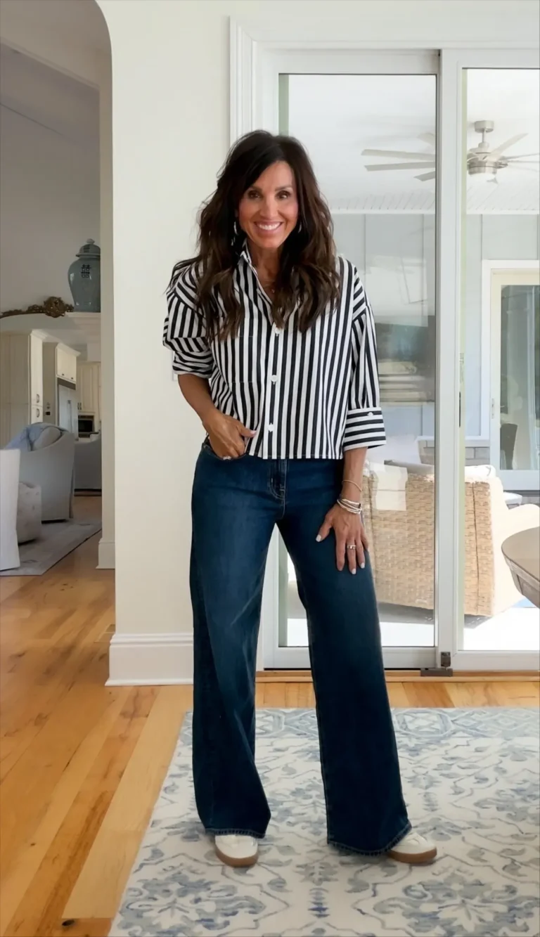 Cyndi wearing a black and white striped button down top.