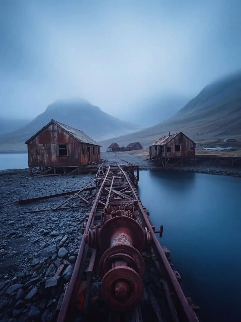 Abandoned rusted whaling station buildings and old machinery on misty shoreline in South Georgia, photographed by nature photographer Christian Hartmann showing historic Antarctic exploration and industry remains.