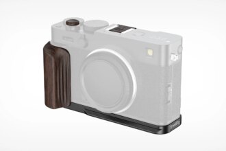 A translucent camera body displaying a dark wooden grip and a black metal baseplate attachment on the left and bottom sides of the camera.
